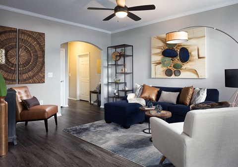 City Place at Westport Modern Living Room with Hardwood Style Floors, Ceiling Fan, and Arched Entry Way